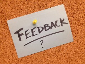 Feedback? - written on a paper pinned to board.