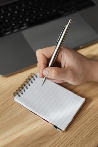 A person writing on a notepad