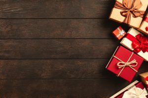 A LOT OF GIFTS KEPT ON A WOODEN TABLE