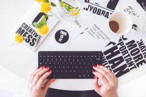 A GIRL TYPING ON LAPTOP